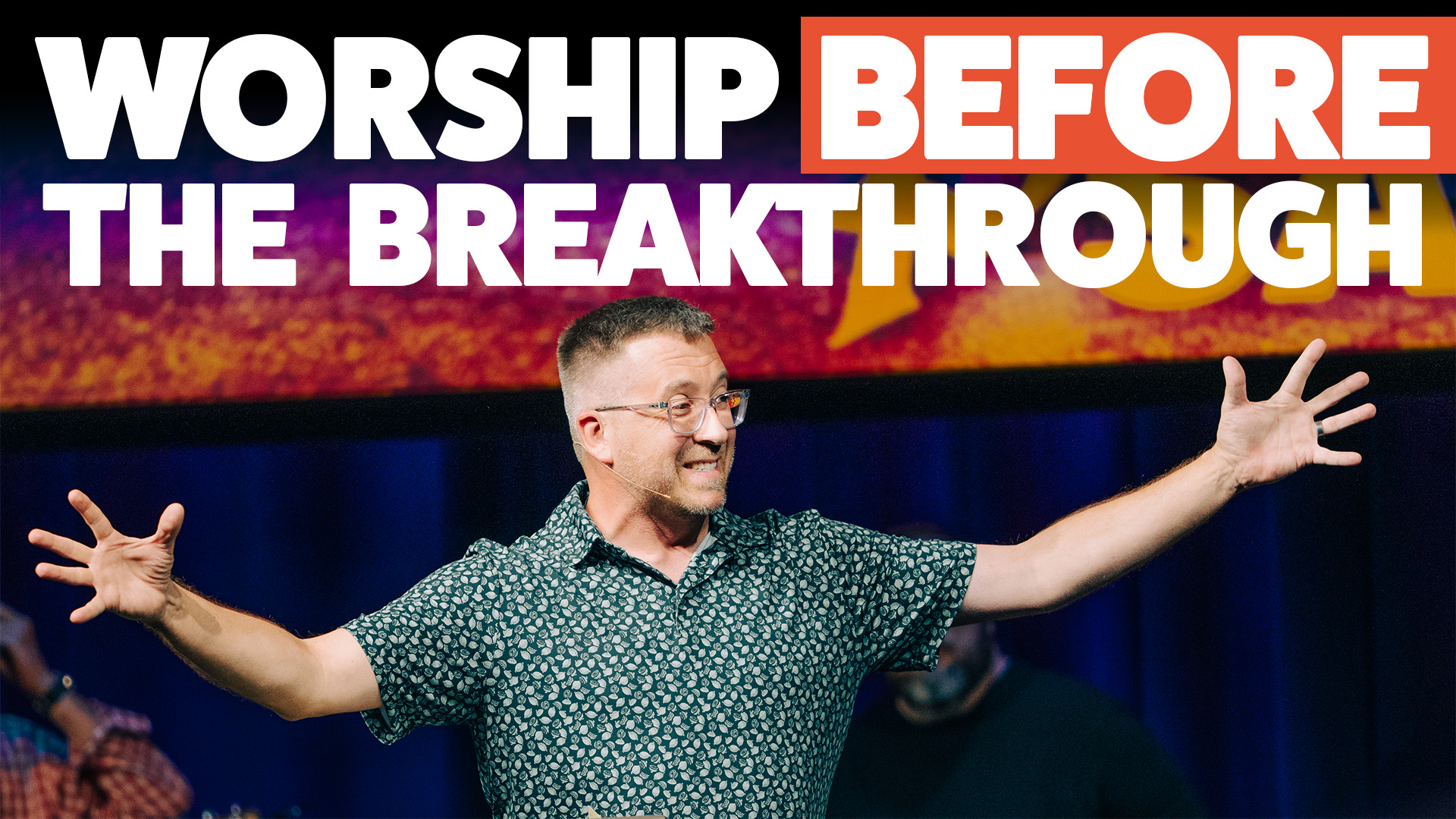 Josh with his arms spread wide under the text that reads Worship Before the breakthrough